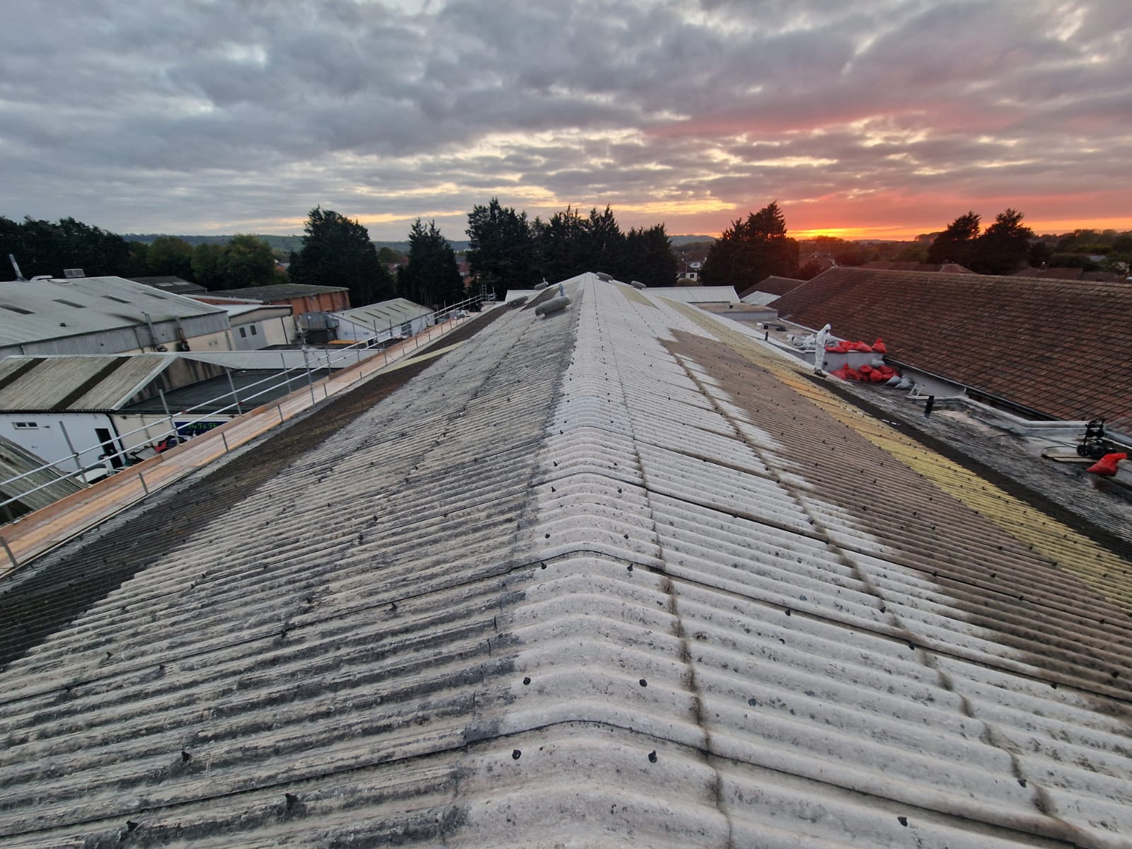 Weathered asbestos cement roofing sheets before Gaco silicone coating