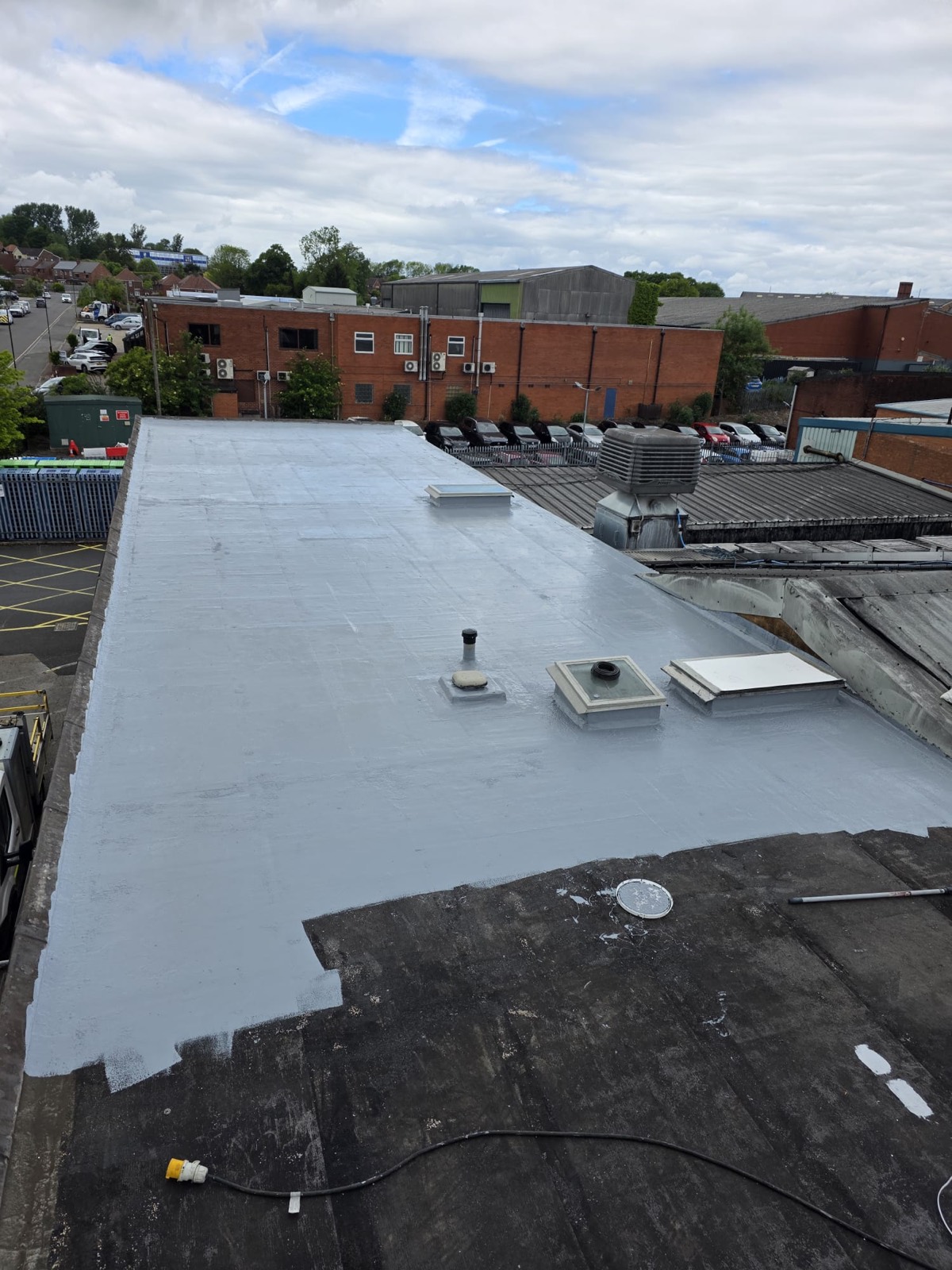 GacoFlex silicone overlay part-applied across the cleaned Heanor flat roof