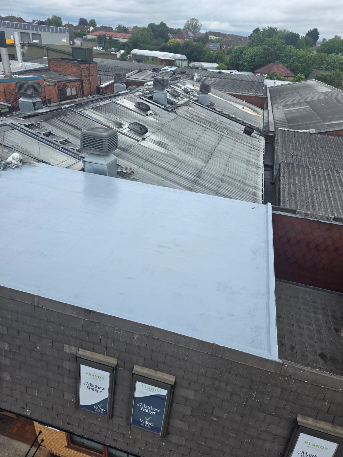 Commercial flat roof in Heanor freshly recoated with grey GacoFlex silicone