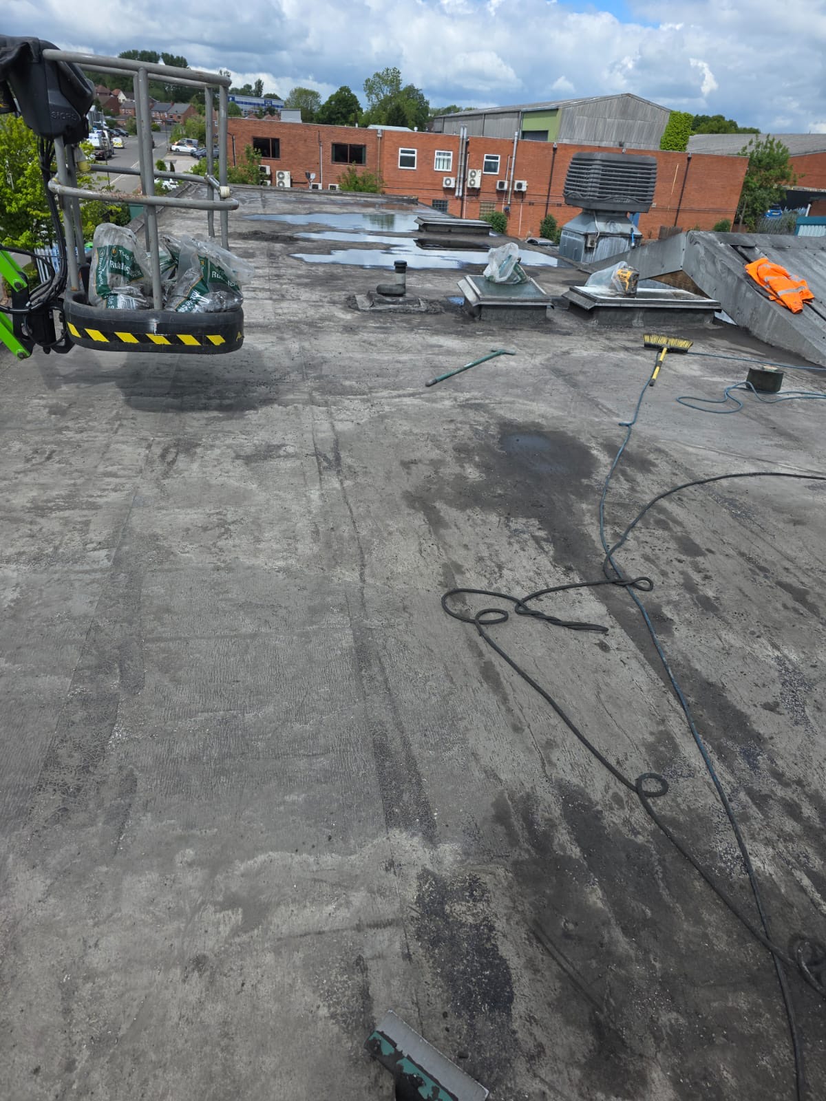 Heanor flat roof stripped of gravel and cleaned back to a sound deck ready for coating
